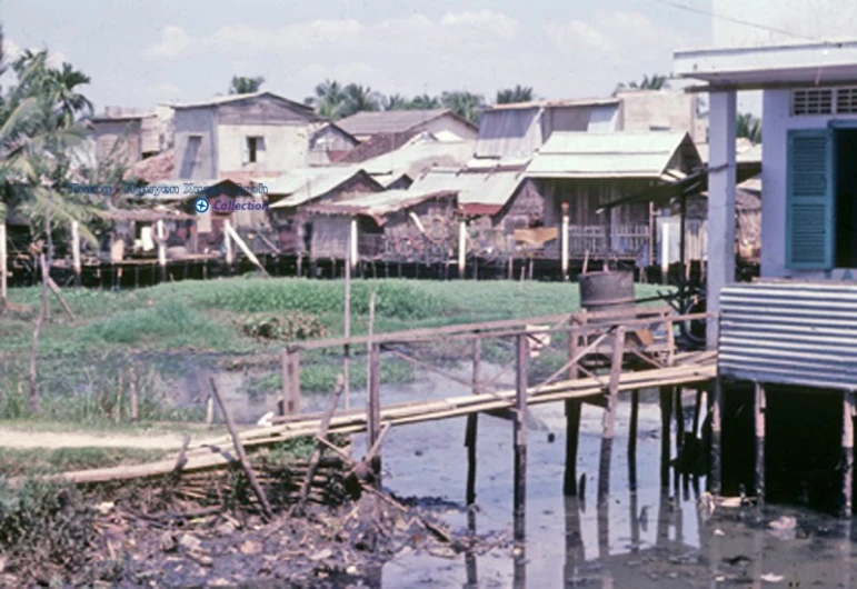 houses and shacks in an old town, with water running from the bottom