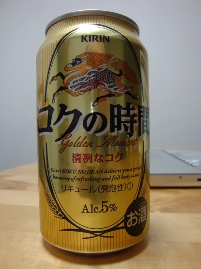 a can of gold beer on a table