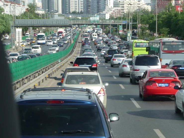 cars travel on a busy highway in the middle of a city