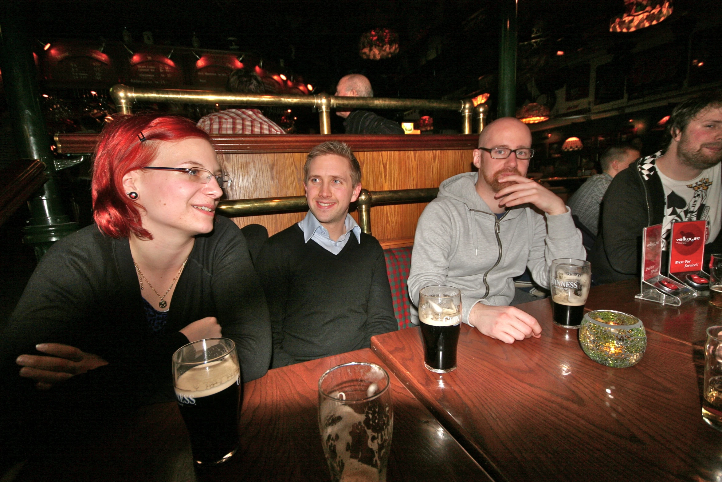 a group of people sitting around a wooden table