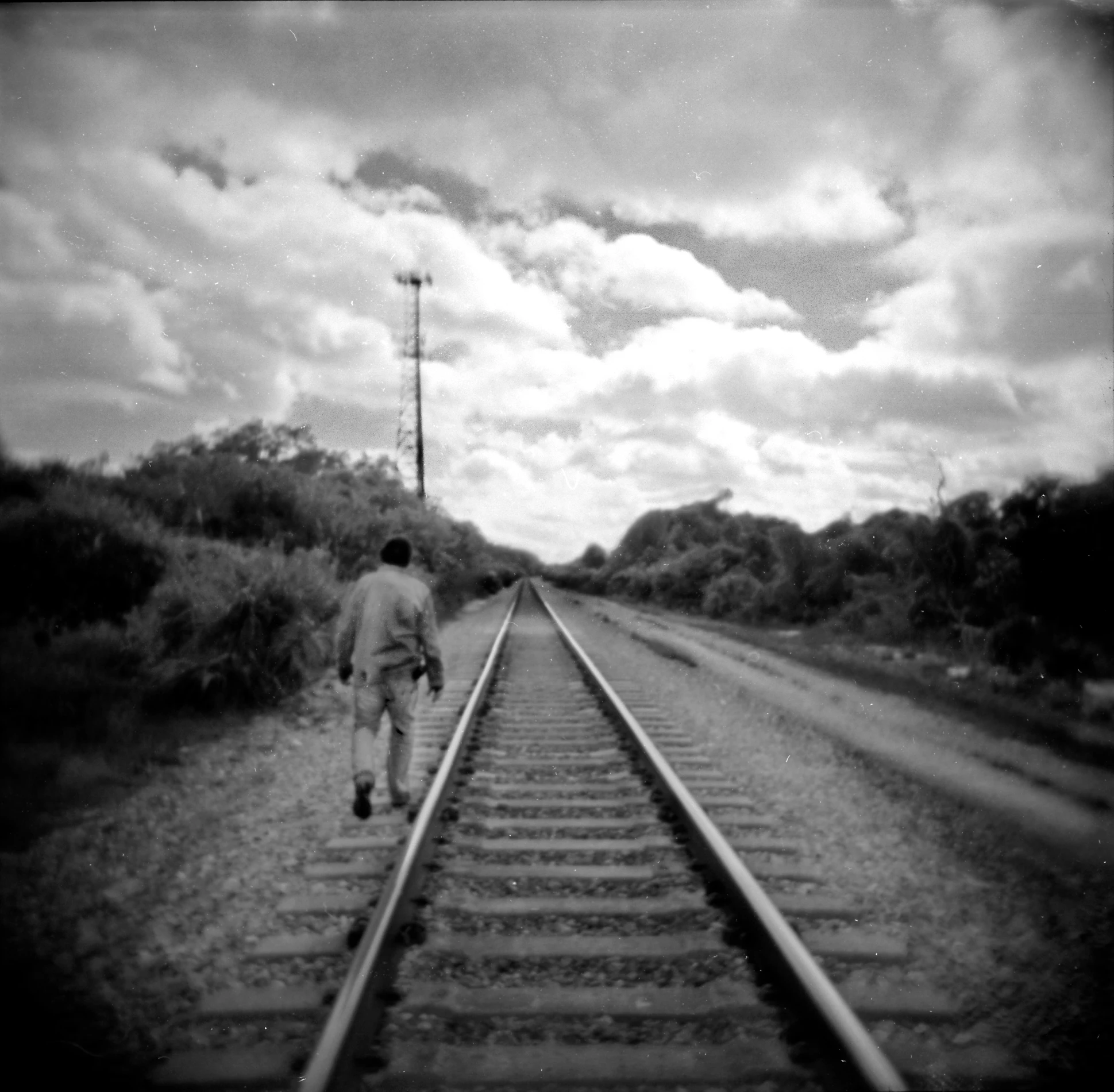 a person is walking along a train track