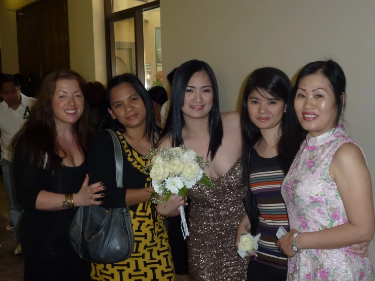 four girls posing with their bouquets in hand