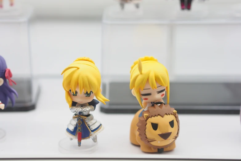 two figurines are sitting on the table together