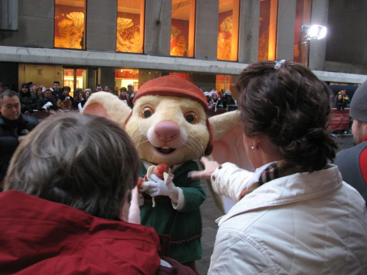 a person in an animal mask next to a mascot