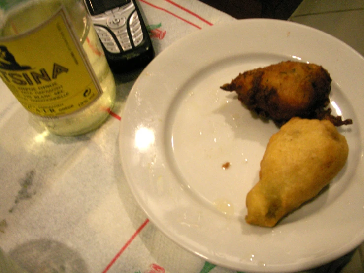 a table set with a glass, fork, cup and some food