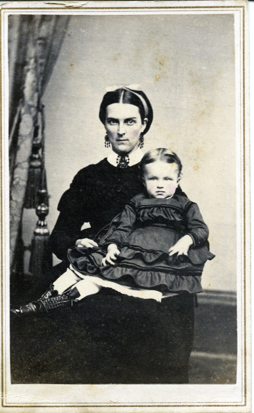 an old picture of a woman holding a small child