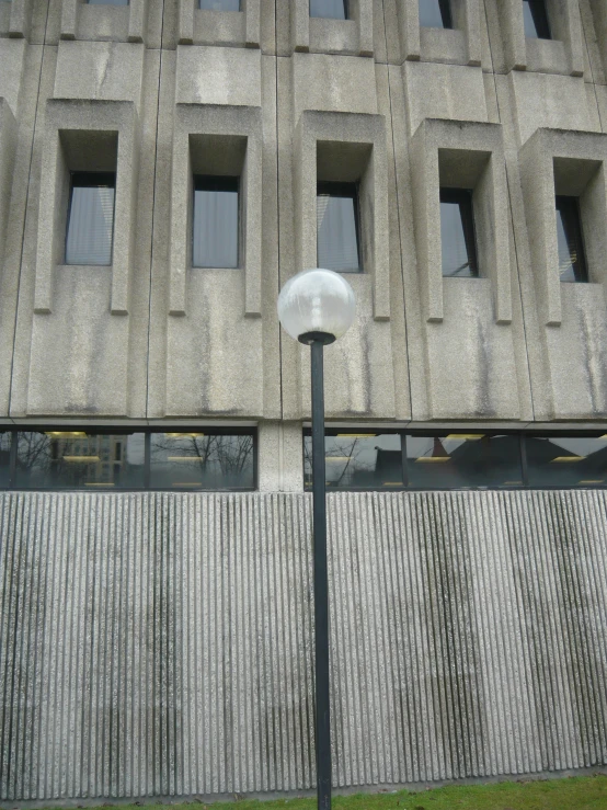 a street light next to a gray stone building