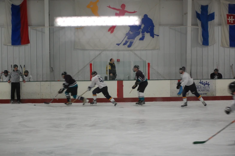 a group of young people playing a game of ice hockey