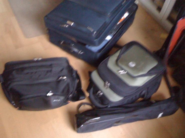 a pile of luggage sitting on the floor next to each other