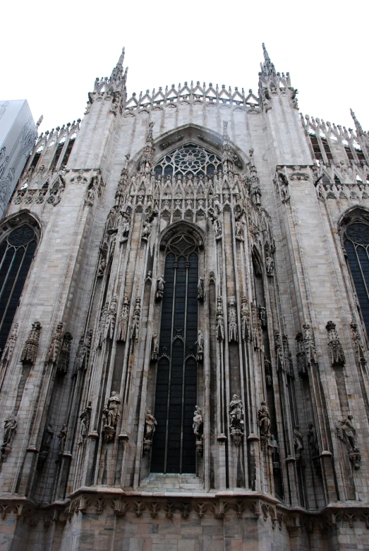 an ornately designed cathedral with multiple statues on its windows