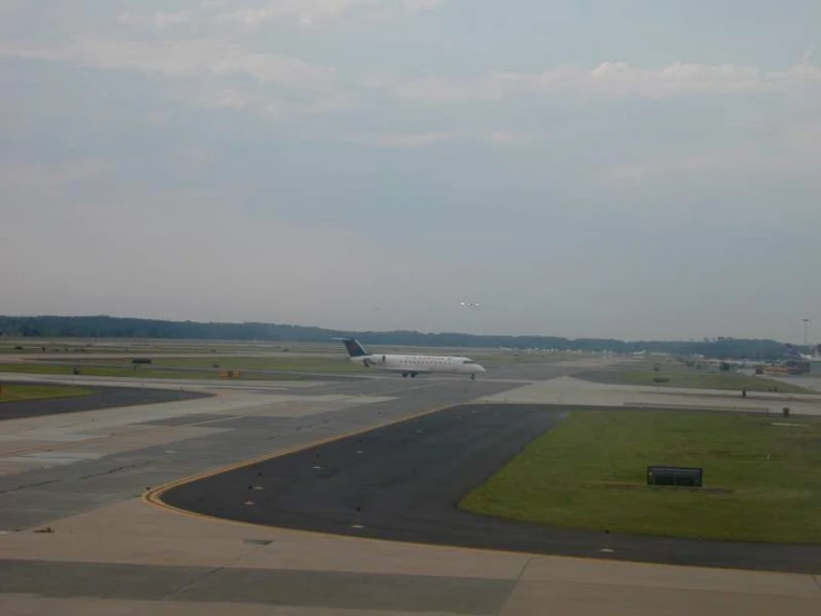 an airport runway with an airplane on it