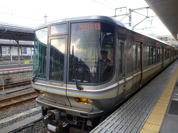 a commuter train stops at an empty station