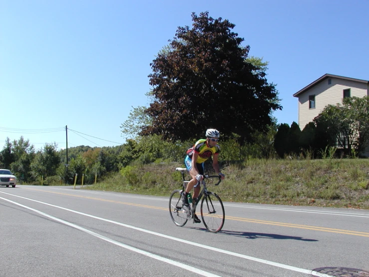 a man rides a bike down the road