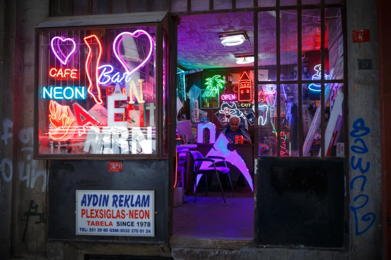 neon signs line the glass windows of this restaurant