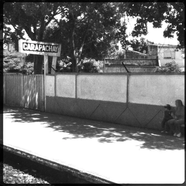 a black and white po of people sitting on the street