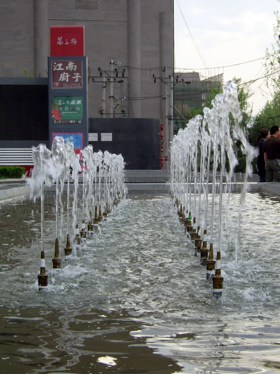 a group of water fountains spewing from each other