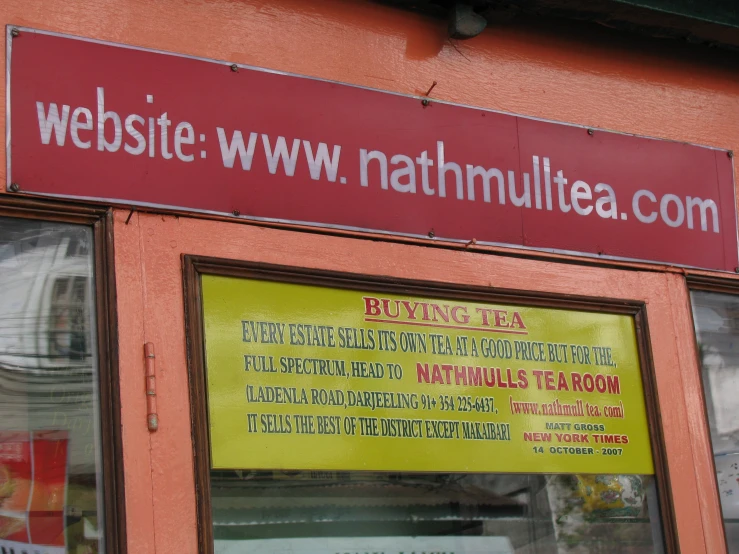 a red and yellow business sign with the name and abbreviation