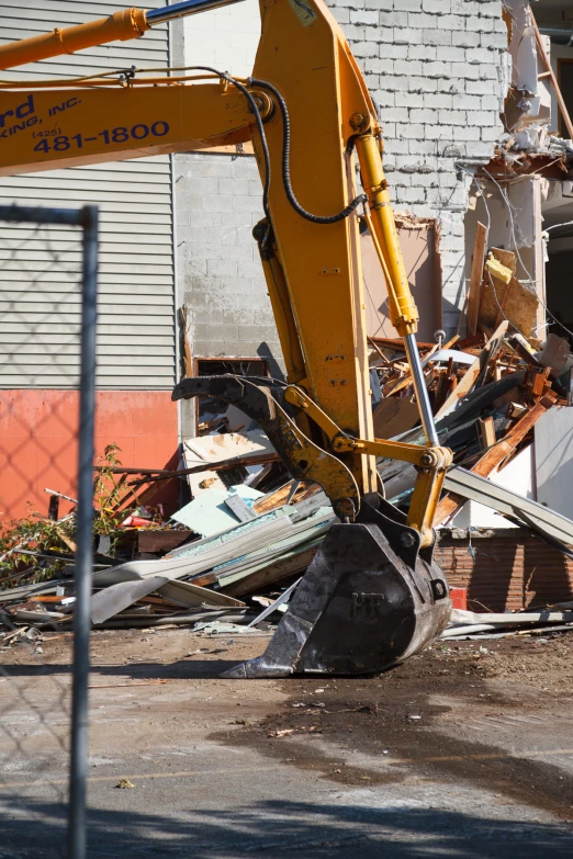 an old digger working on a pile of rubble