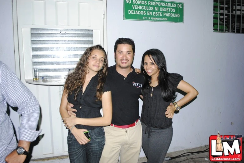 a couple of people posing in front of a building