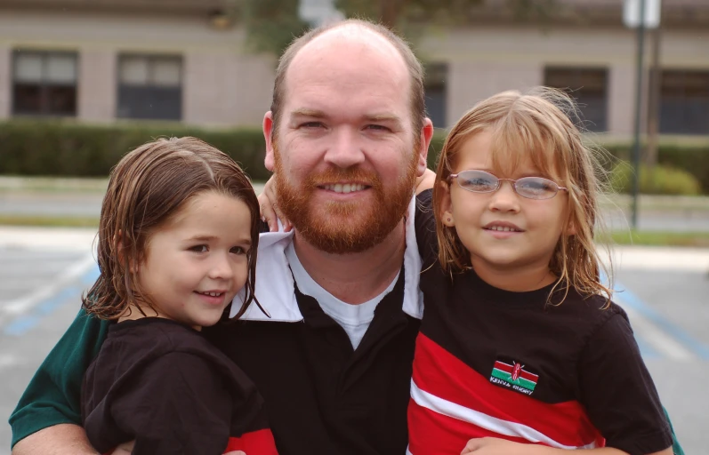 a man with two small girls and a man