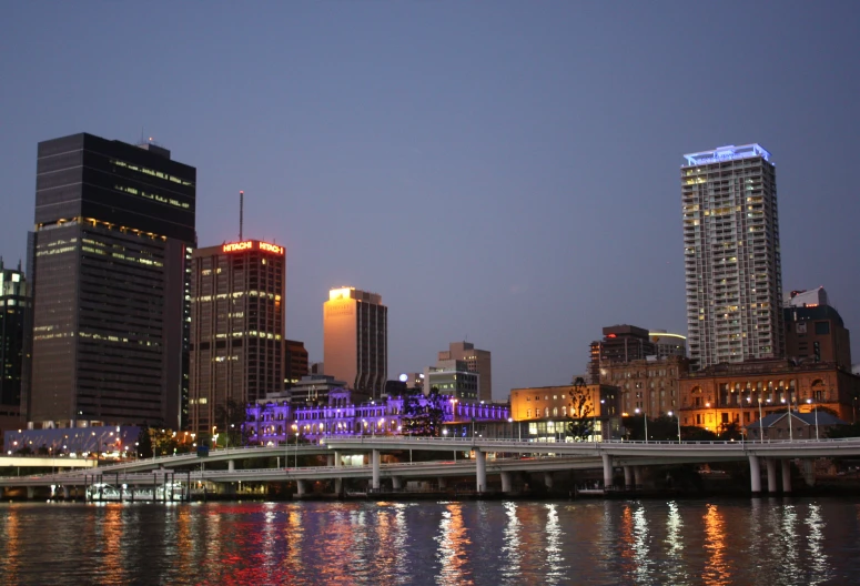 the buildings of a city are lit up with bright lights