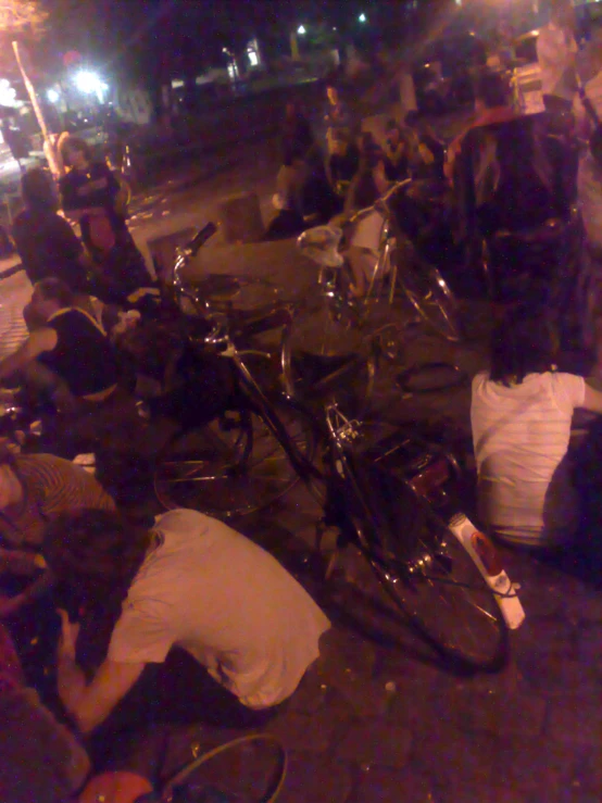 the motorcycle in front of a group of people is lying on it's side