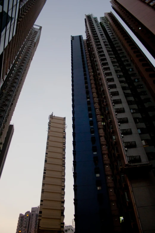 tall buildings on the street at sunset with skyscrs in the foreground