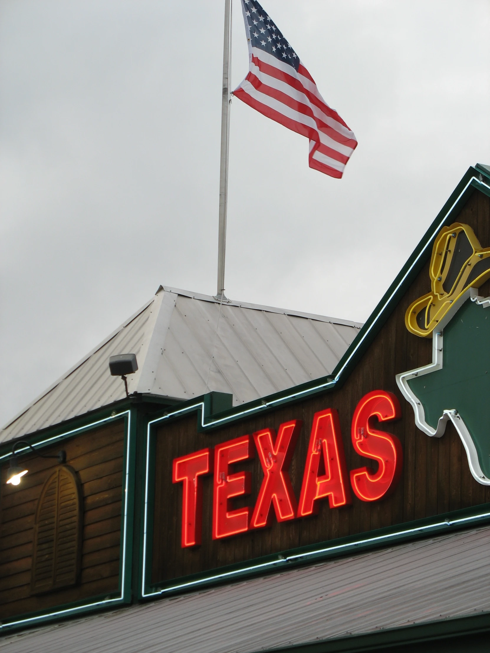 a large texas shaped store with flags and buildings