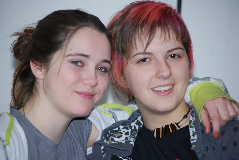 two girls smiling and wearing gray and yellow