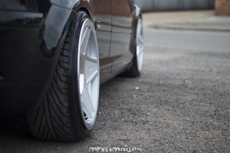 a car's front tire is shown from the perspective of it