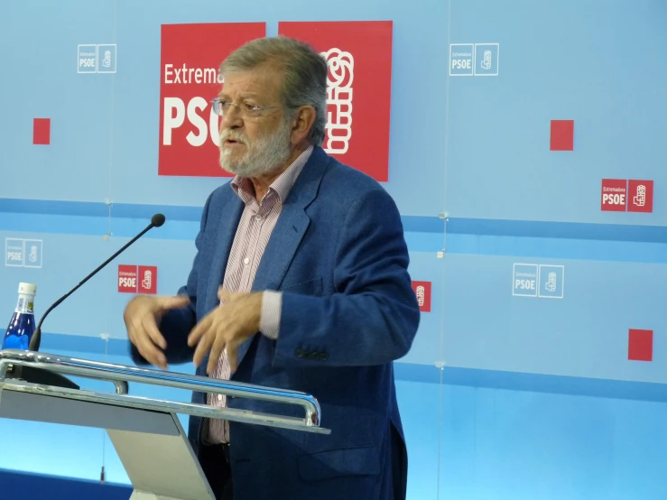 a man wearing a suit at a podium