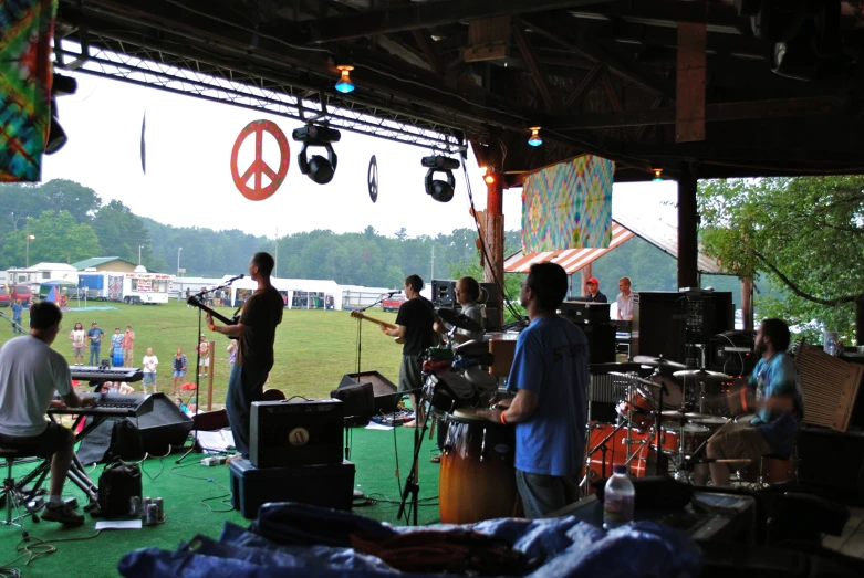 people at a concert playing drums and guitar