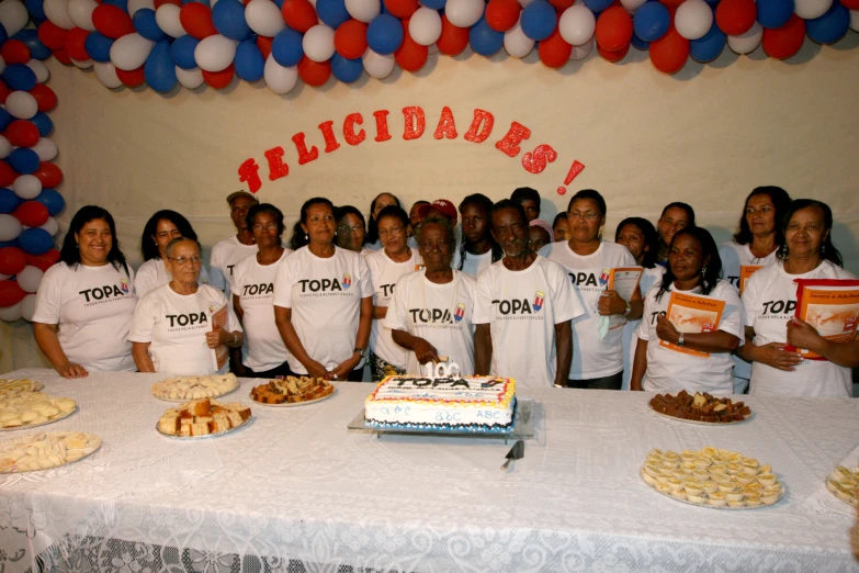 a group of people posing in front of a table