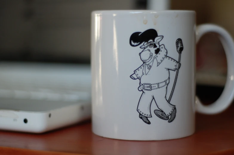 there is a coffee mug with a picture of a man holding a baseball bat