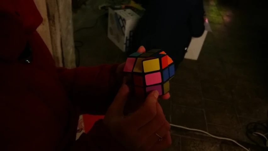 a person holding a rubik cube in their hands