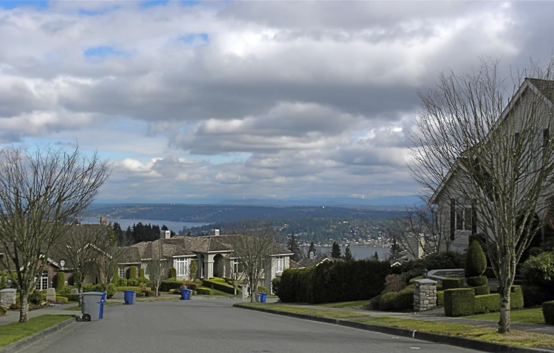 a city street that leads to an area with houses and trees