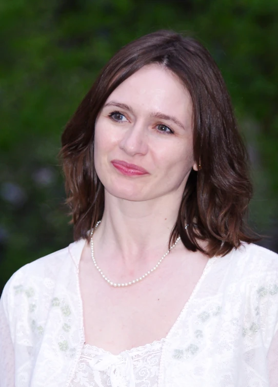 a beautiful woman with long hair wearing a necklace