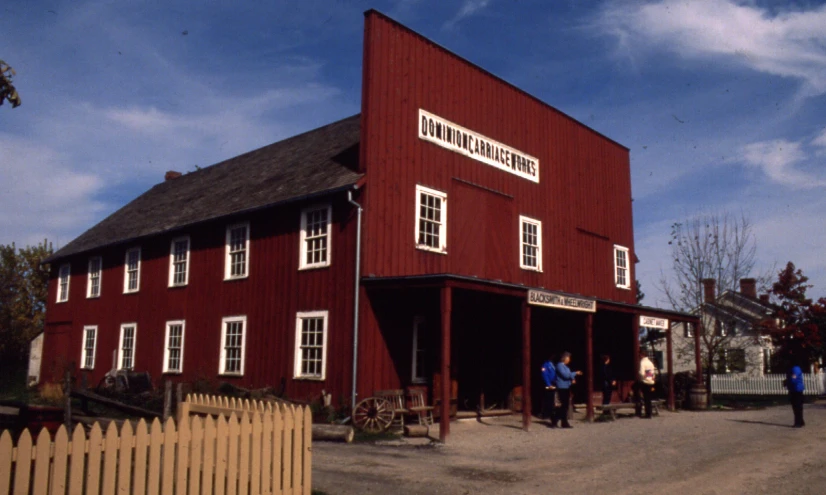 a red building with some people walking by