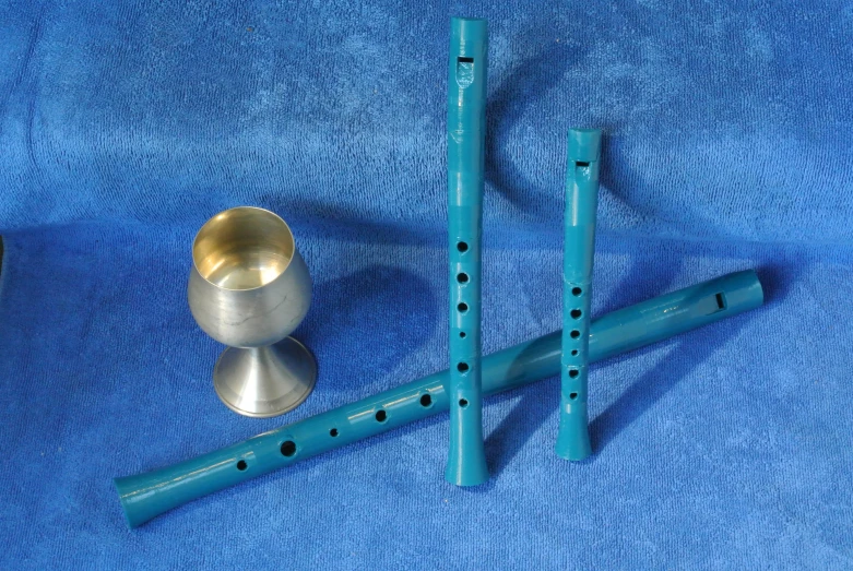 three pieces of blue metal are resting on a blue fabric