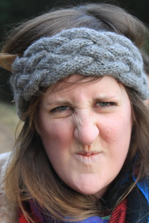 a woman's head wearing a hat and scarf