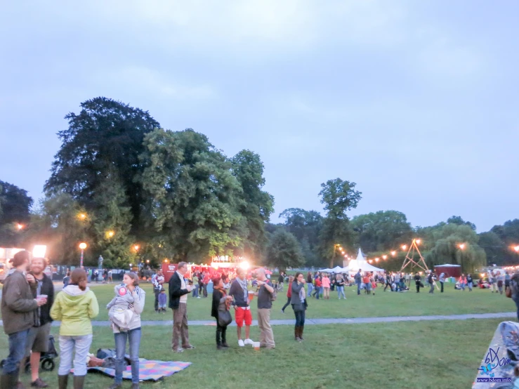 several people standing around in a grassy field