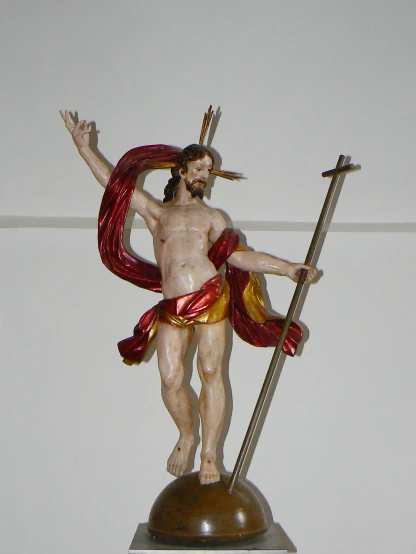 a statue of jesus holding the cross and a spear