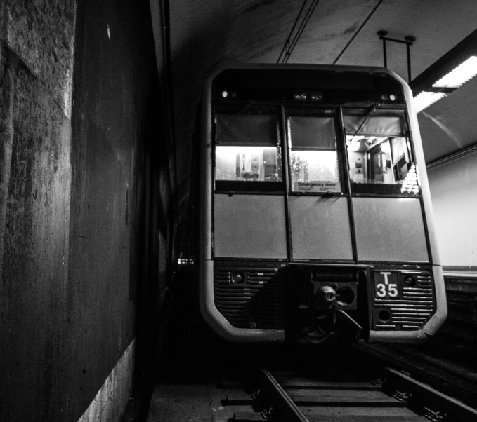 black and white pograph of an old looking train in a train station