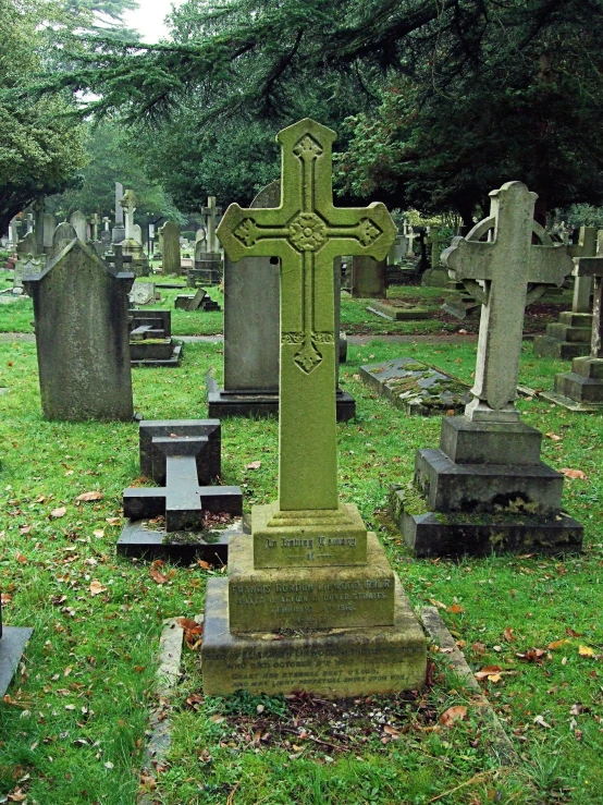 the cemetery has many headstones with crosses and grave markers