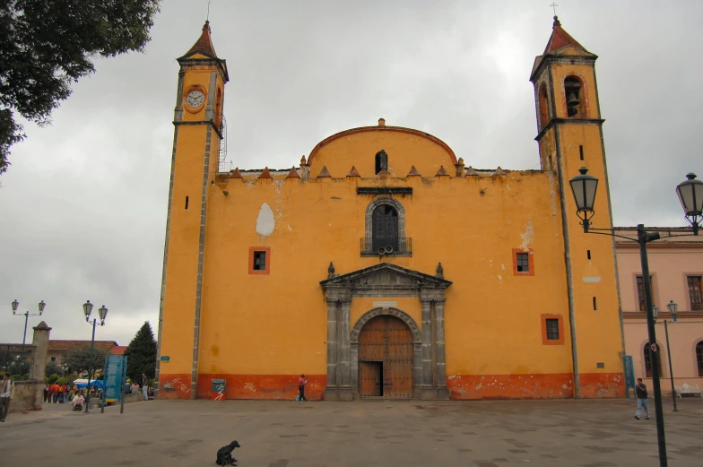 the old yellow building is located under a cloudy sky