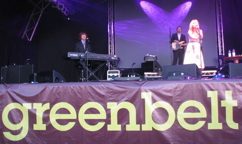 three people on stage playing music with their instruments