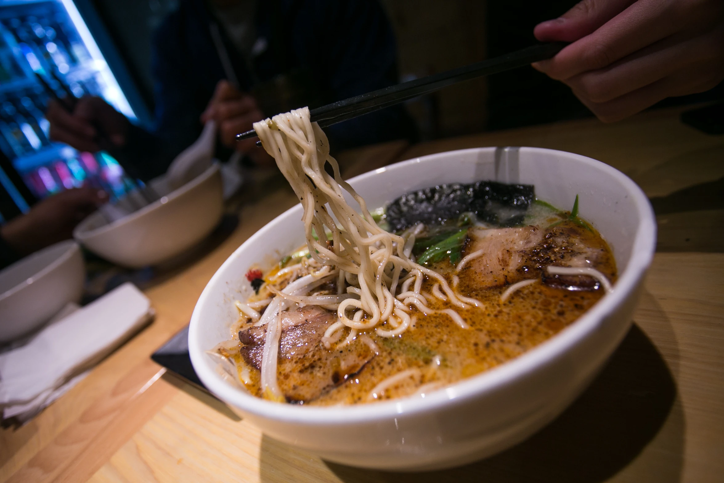 a white bowl of food sitting on top of a table