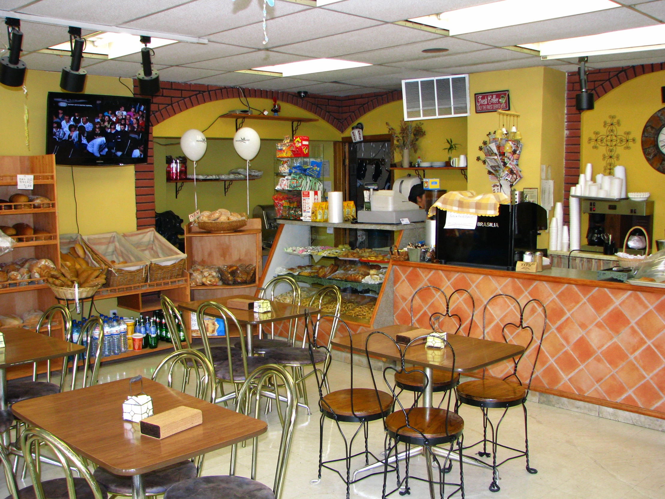 an interior s of a restaurant with tables, chairs and a wall clock