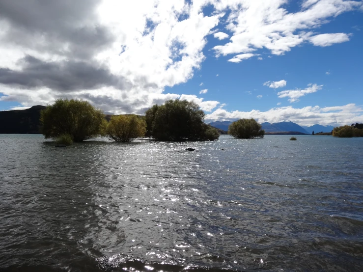 the water is very calm as the clouds hang low