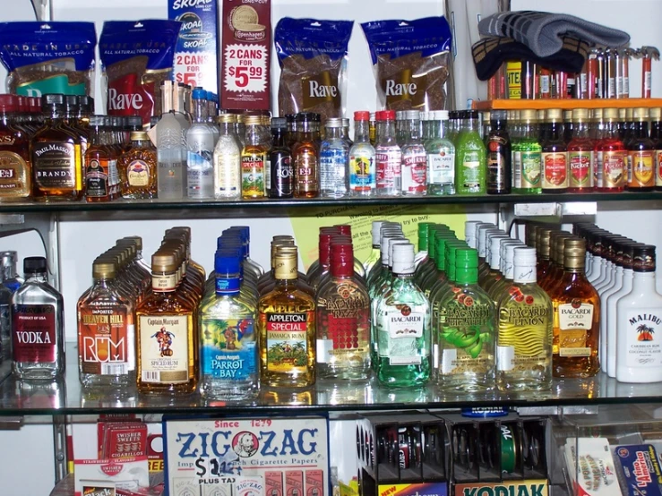a shelf filled with different liquor bottles in a room